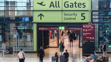 Menschen gehen durch das Terminal vom Flughafen BER