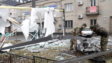 Polizisten inspizieren in Kiew die Überreste einer Rakete, die auf die Straße gefallen ist.