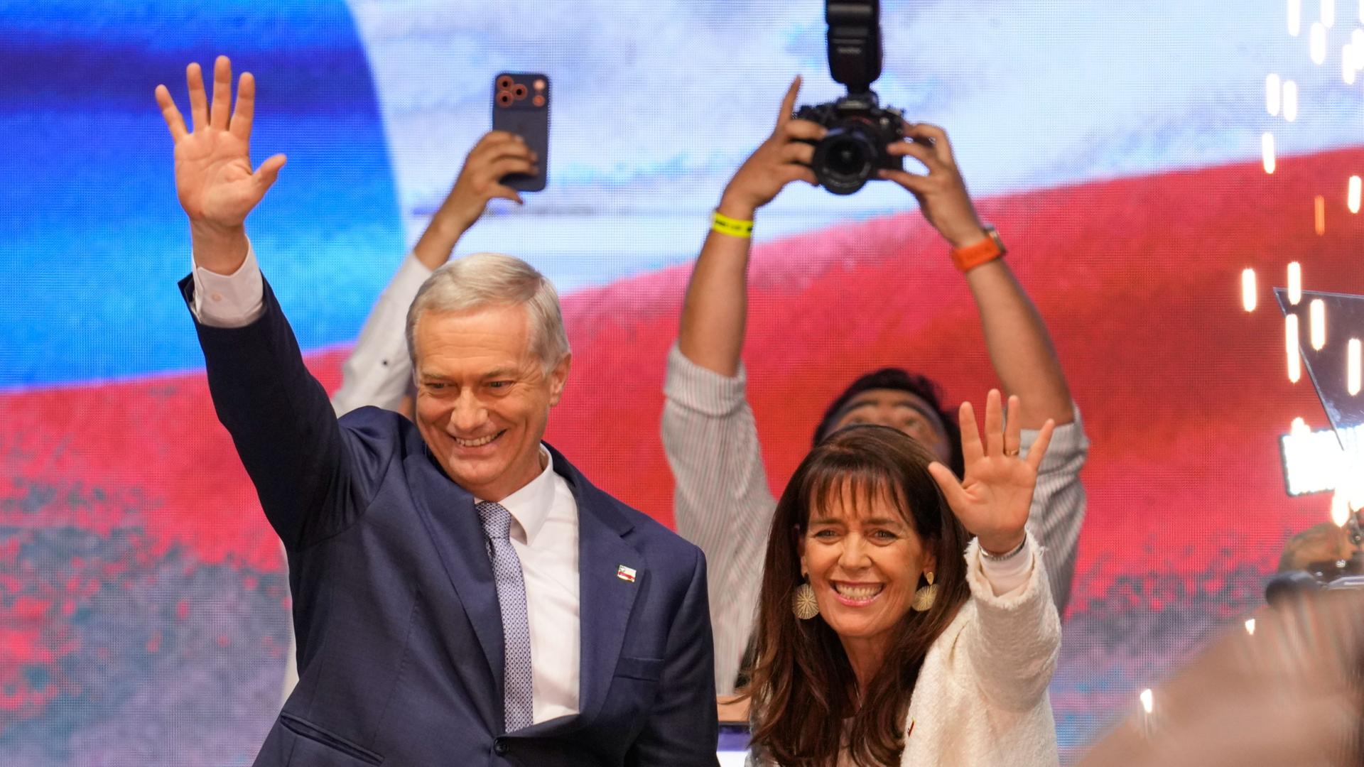 Präsidentschaftskandidat José Antonio Kast von der oppositionellen Republikanischen Partei und seine Frau Maria Pia Adriasola winken ihren Anhängern zu. | dpa