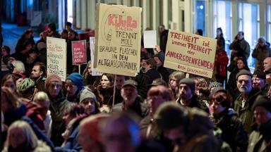 Mit Plakaten und Sprechchören demonstrieren Teilnehmer auf dem Marktplatz in Schwerin gegen Rechtsextremismus.