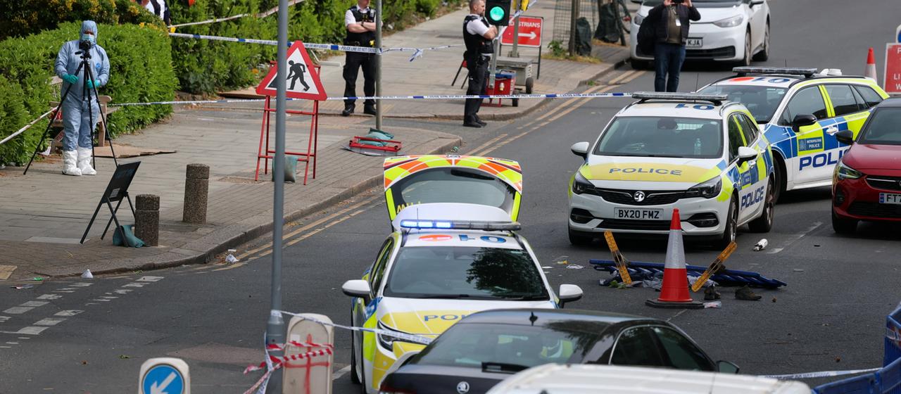 A forensics team is seen at a crime scene in London's Golders Green district.