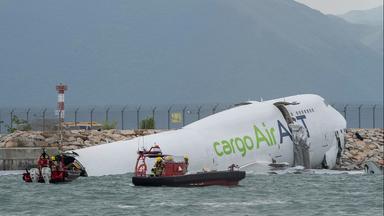 Rettungskräfte in Booten vor verunglücktem Frachtflugzeug