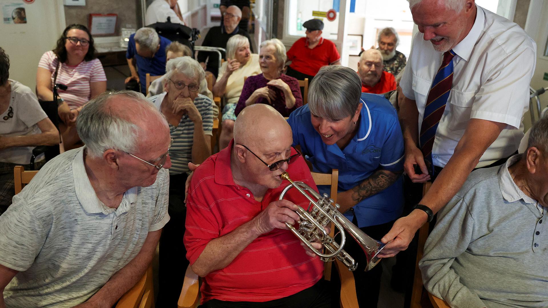 Der 87-jährige Bewohner des Pflegeheims Pelton Grange spielt ein Blechblasinstrument. | REUTERS