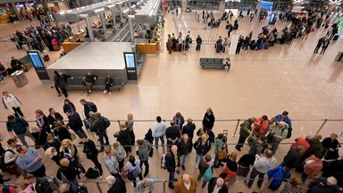 Passagiere stehen Schlange im Terminal des Hamburger Flughafens