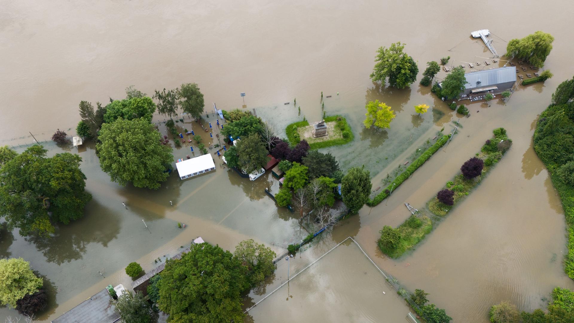 Luftaufnahme, Blick auf Gebäude, die von Hochwasser umgeben sind. Straßen sind überflutet und nicht mehr zu erkennen. | Boris Roessler