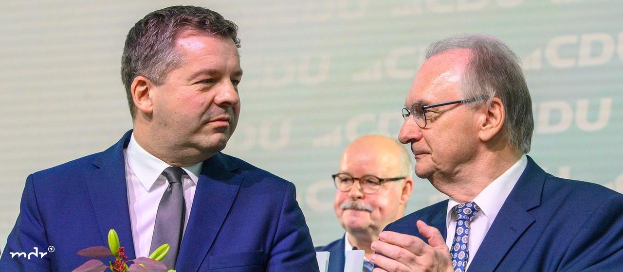 Sven Schulze (l), Vorsitzender der CDU Sachsen-Anhalt und Spizenkandidat der CDU bei der Landtagswahl 2026 steht nach seiner Wiederwahl mit Blumen auf der Bühne des Landesparteitages der CDU Sachsen-Anhalt. Neben ihm steht Reiner haseloff (CDU), Ministerpräsident des Landes Sachsen-Anhalt und applaudiert