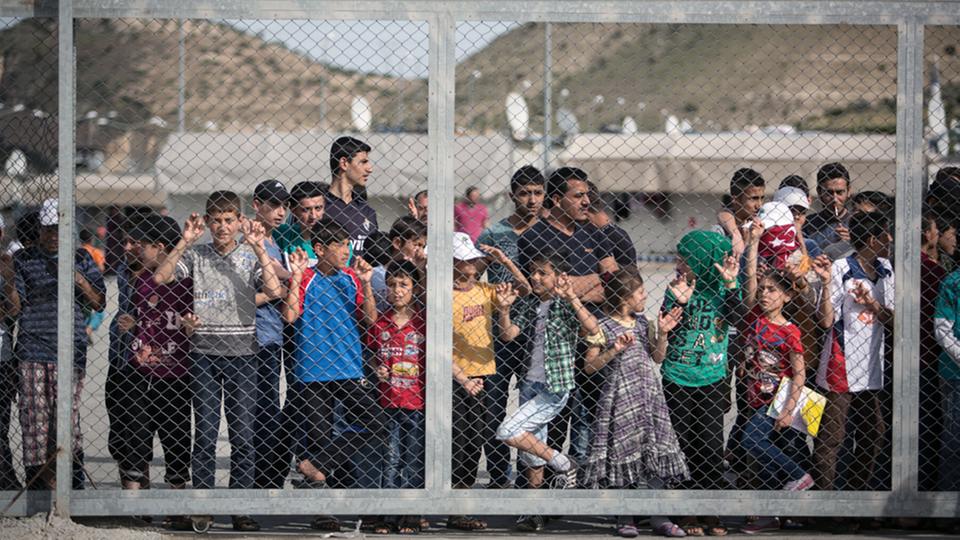 Flüchtlinge stehen hinter einem Zaun in Gaziantep, Türkei.