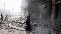 Menschen gehen durch Trümmer im südlichen Stadtteil al-Zeitoun in Gaza-Stadt.
