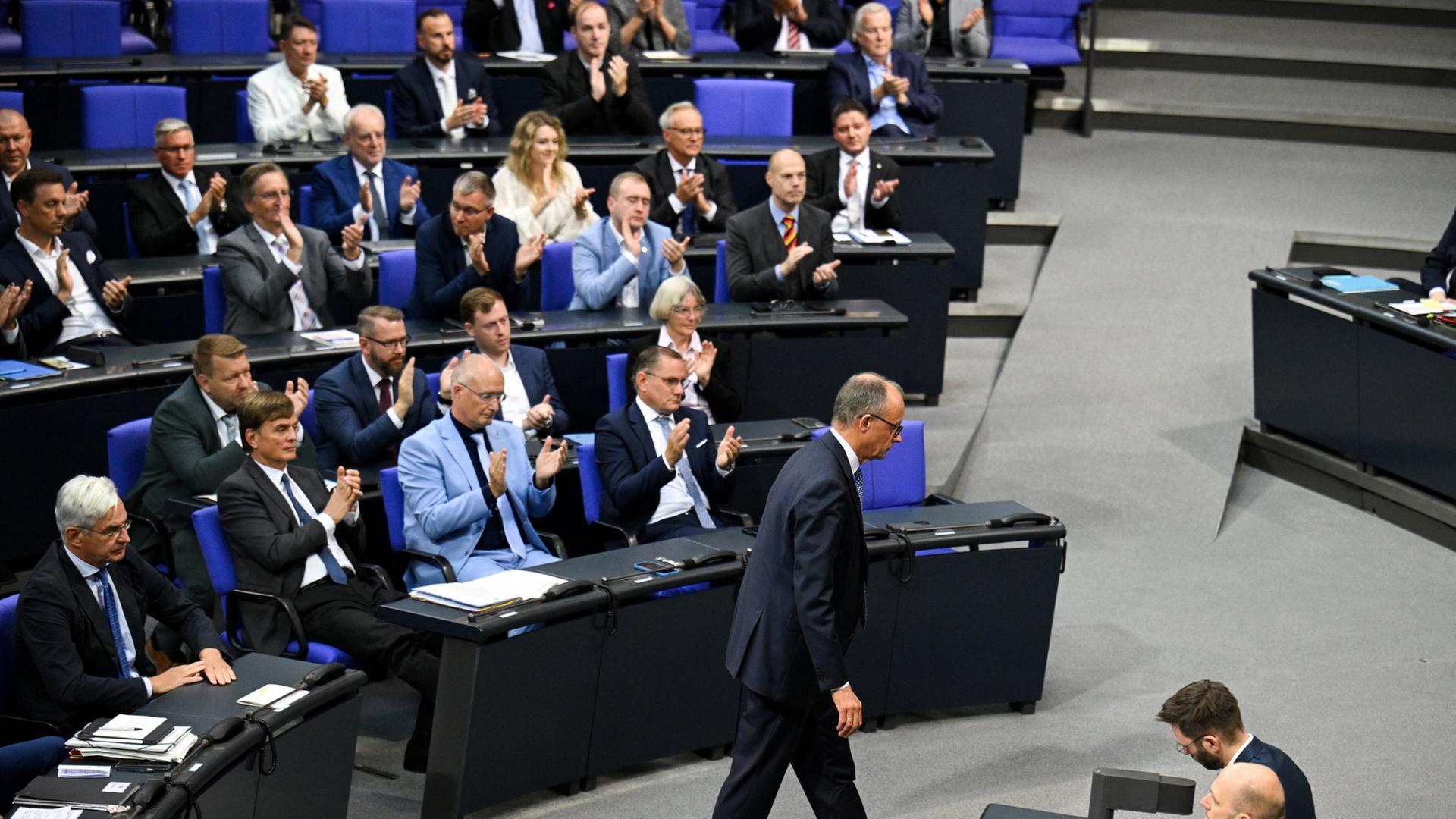 Friedrich Merz läuft vor der AfD-Fraktion im Bundestag her. | REUTERS