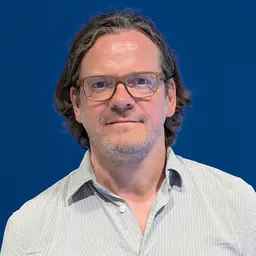 Mann mit Brille und nackenlagen Haaren