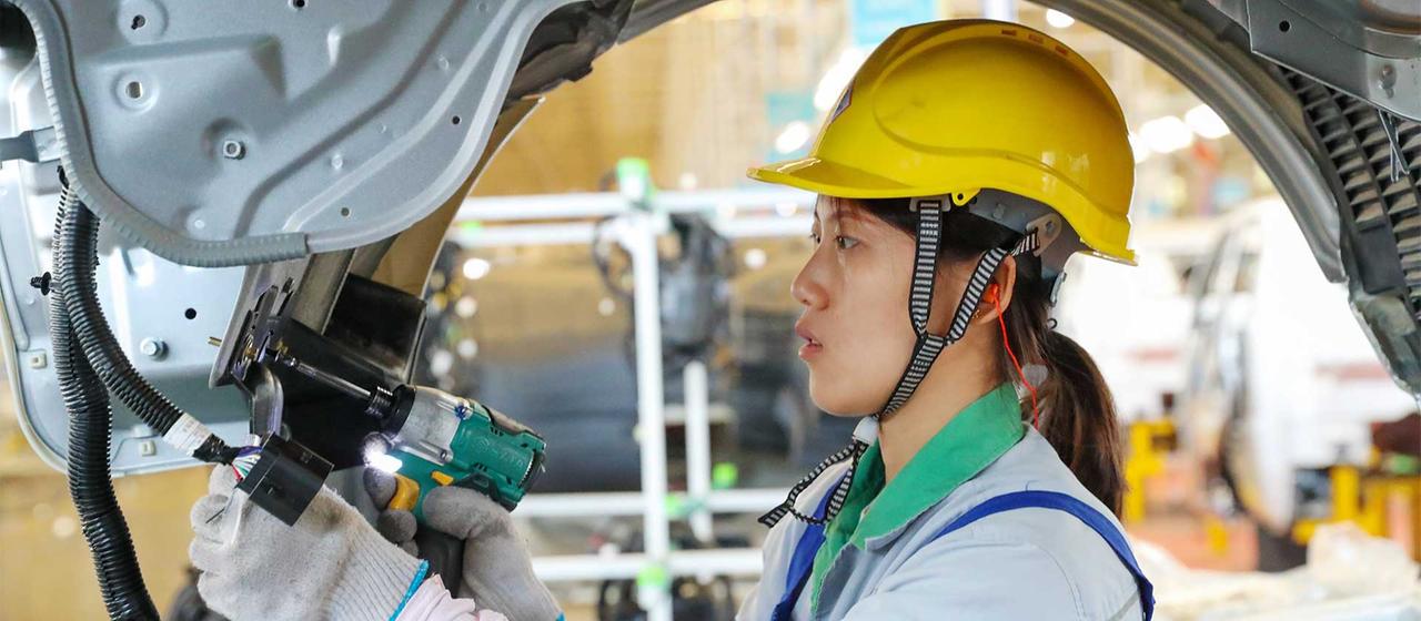 Arbeiterin in der Fahrzeugmontage  der Wuzheng Group, Provinz Shandong, China.