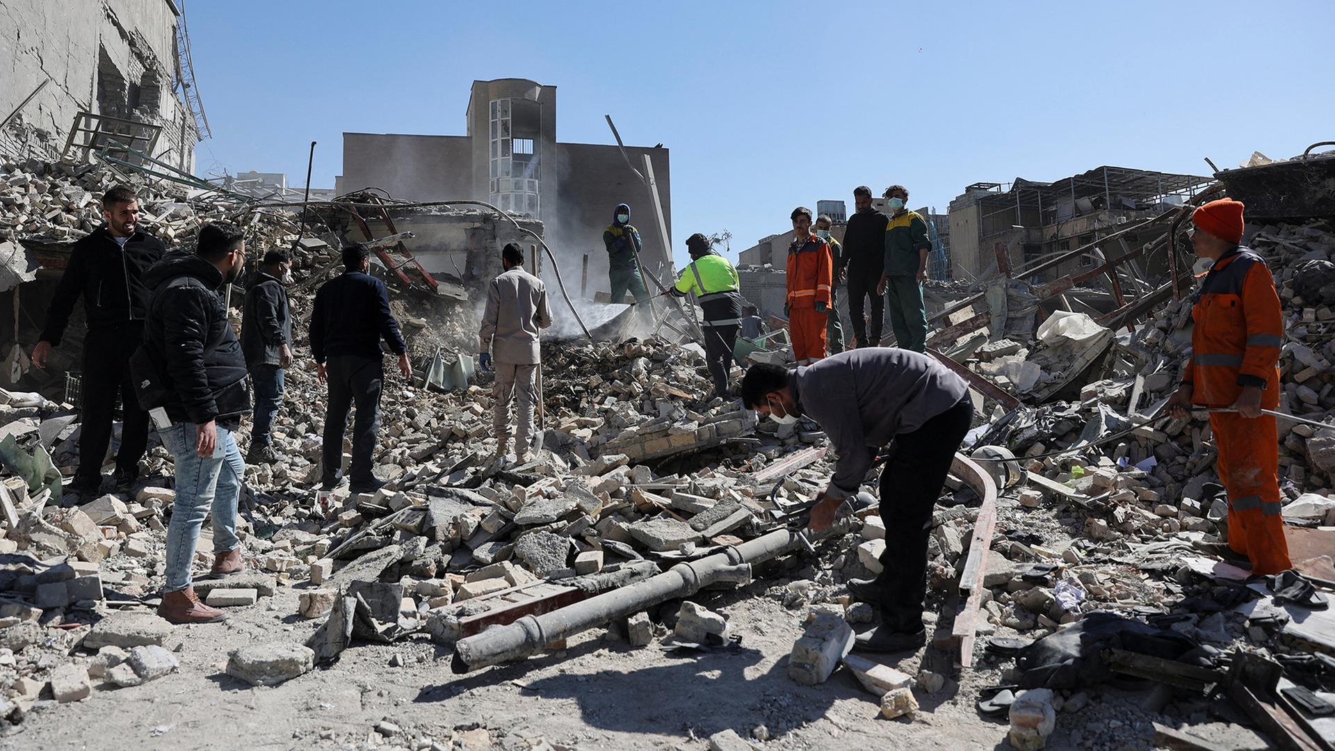 Menschen stehen vor Trümmern vor einer Polizeistation in Teheran. | Majid Asgaripour/WANA (West Asia News Agency) via REUTERS