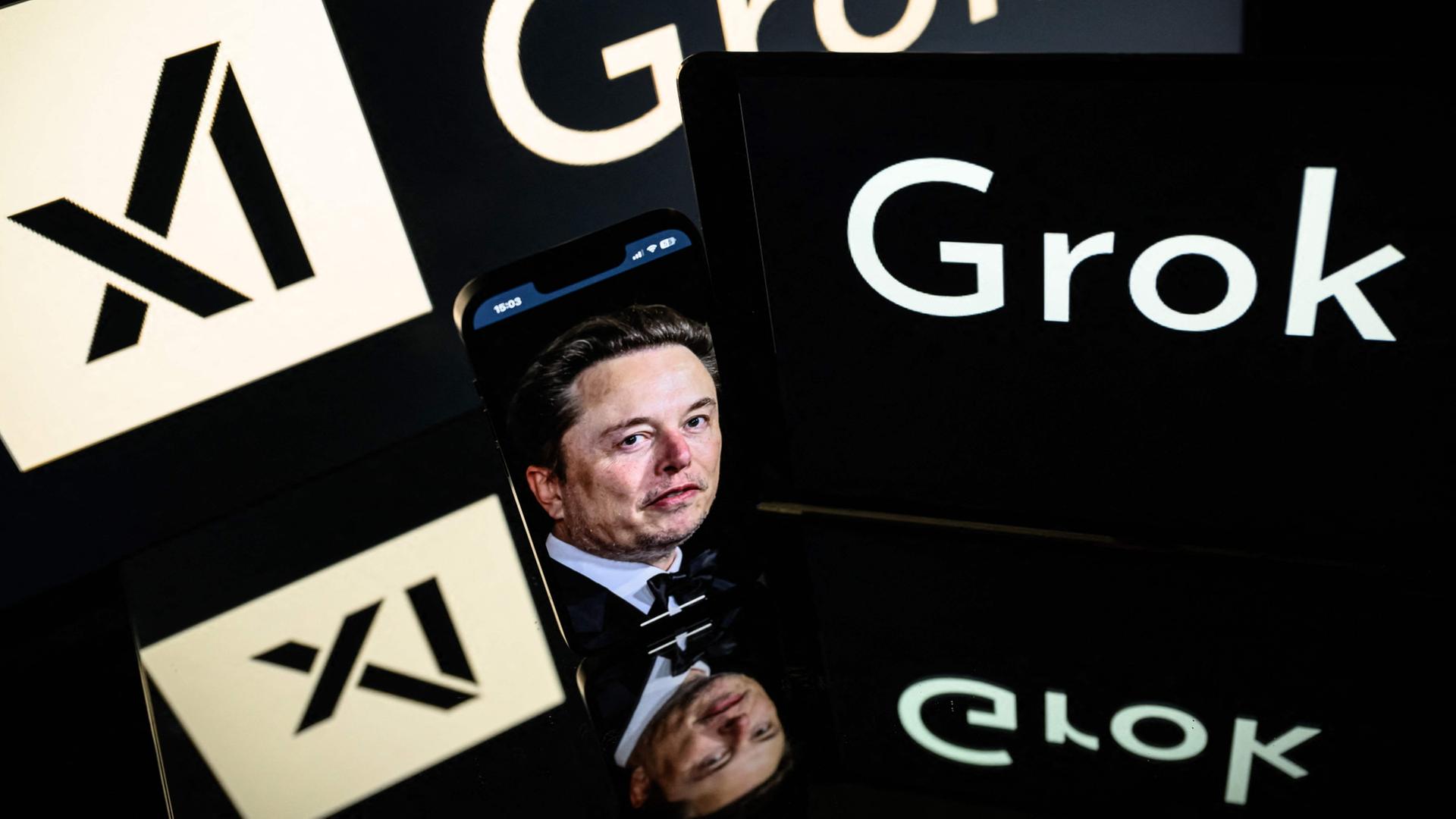 Bildschirme zeigen die Logos von Grok, xAI und Elon Musk. (Archiv) | AFP