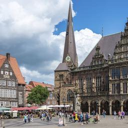 Menschen laufen an einem Sommertag über die Bremer Domsheide.