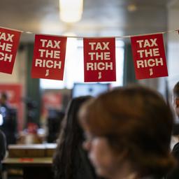  Kleine Fähnchen mit der Aufschrift "Tax the rich" hängen in Bern über den Tischen am Tag der Volksabstimmung in der Schweiz