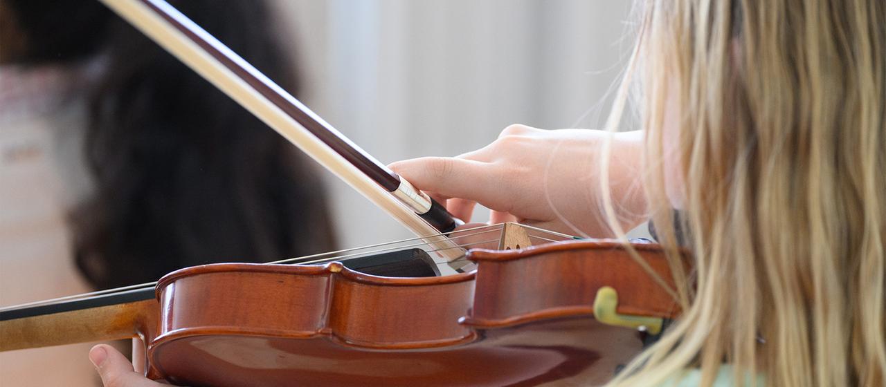 A girl plays a violin.