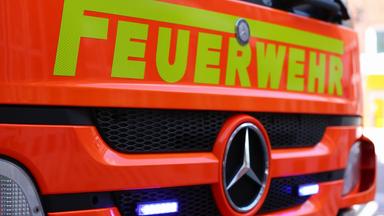 Schriftzug "Feuerwehr" ist auf der roten Motorhaube eines Feuerwehrautos zu sehen.