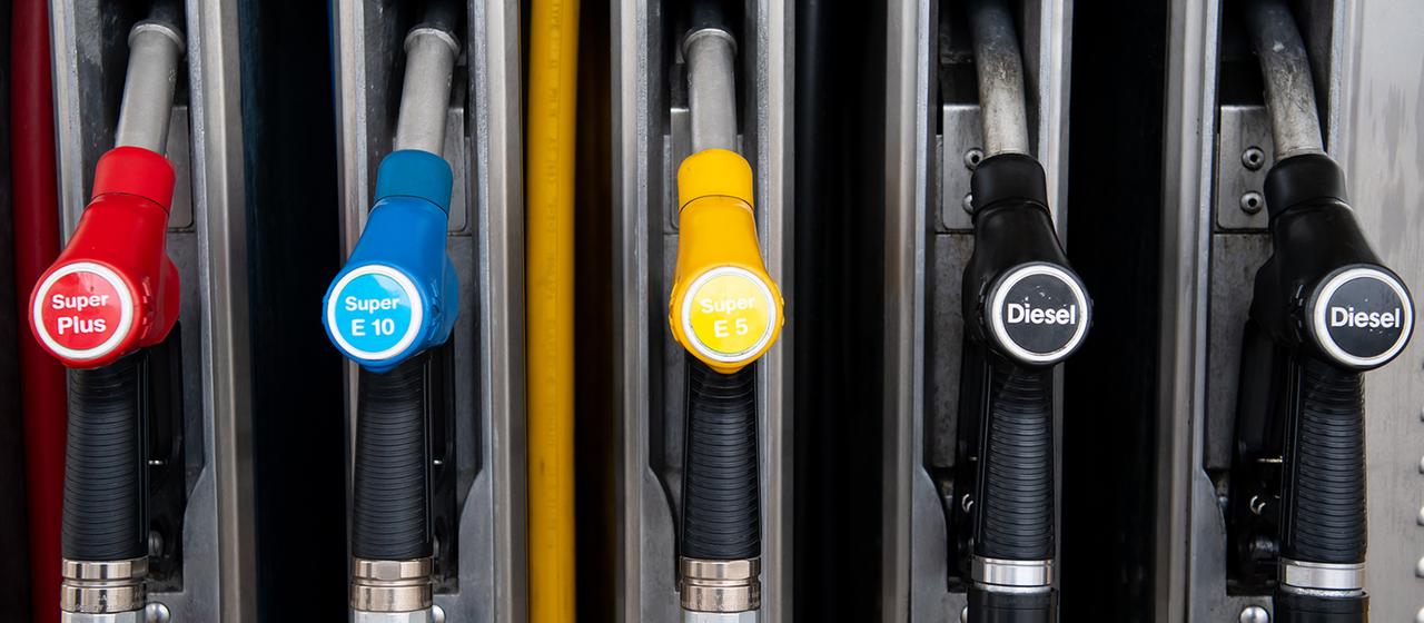  Zapfpistolen für verschiedene Kraftstoffarten hängen an einer Zapfsäule an einer Tankstelle