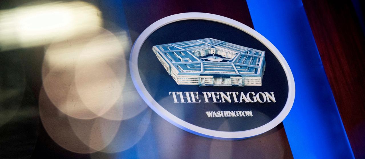 The Pentagon logo can be seen behind the podium in the Pentagon press room