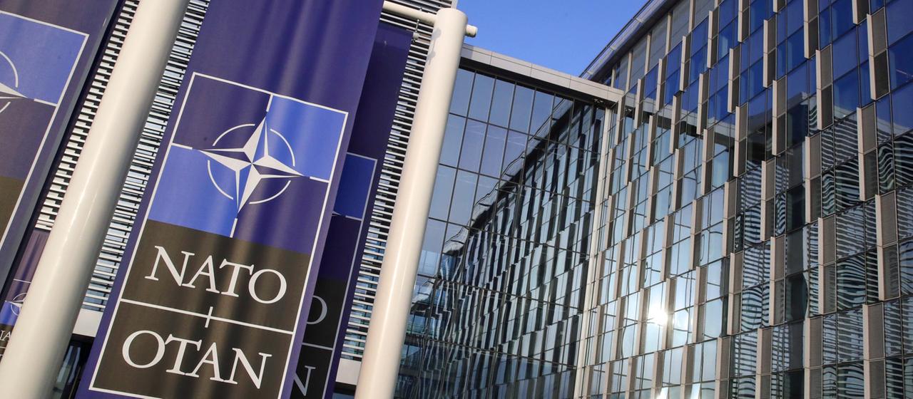Flags with the NATO logo fly in front of the NATO headquarters in Brussels
