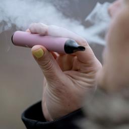 Eine Frau raucht eine Einweg-E-Zigarette