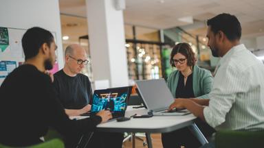 Wissenschaftler des Exzellenzclusters "CISPA" sitzen an einem Tisch.