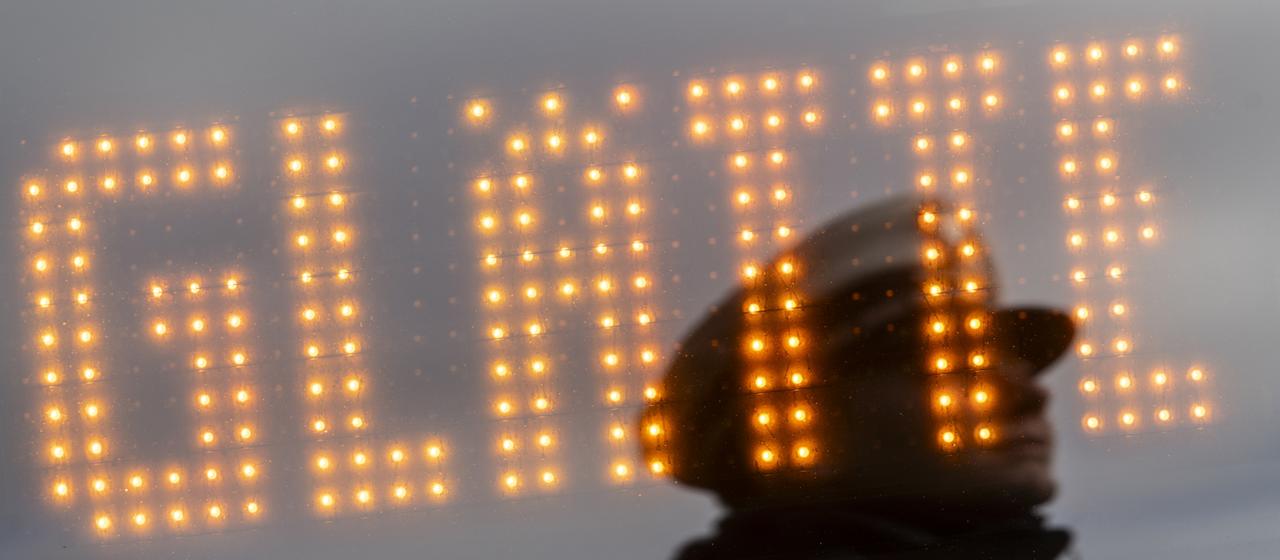 Ein Leuchtschild weist auf Glätte hin (Archivbild).