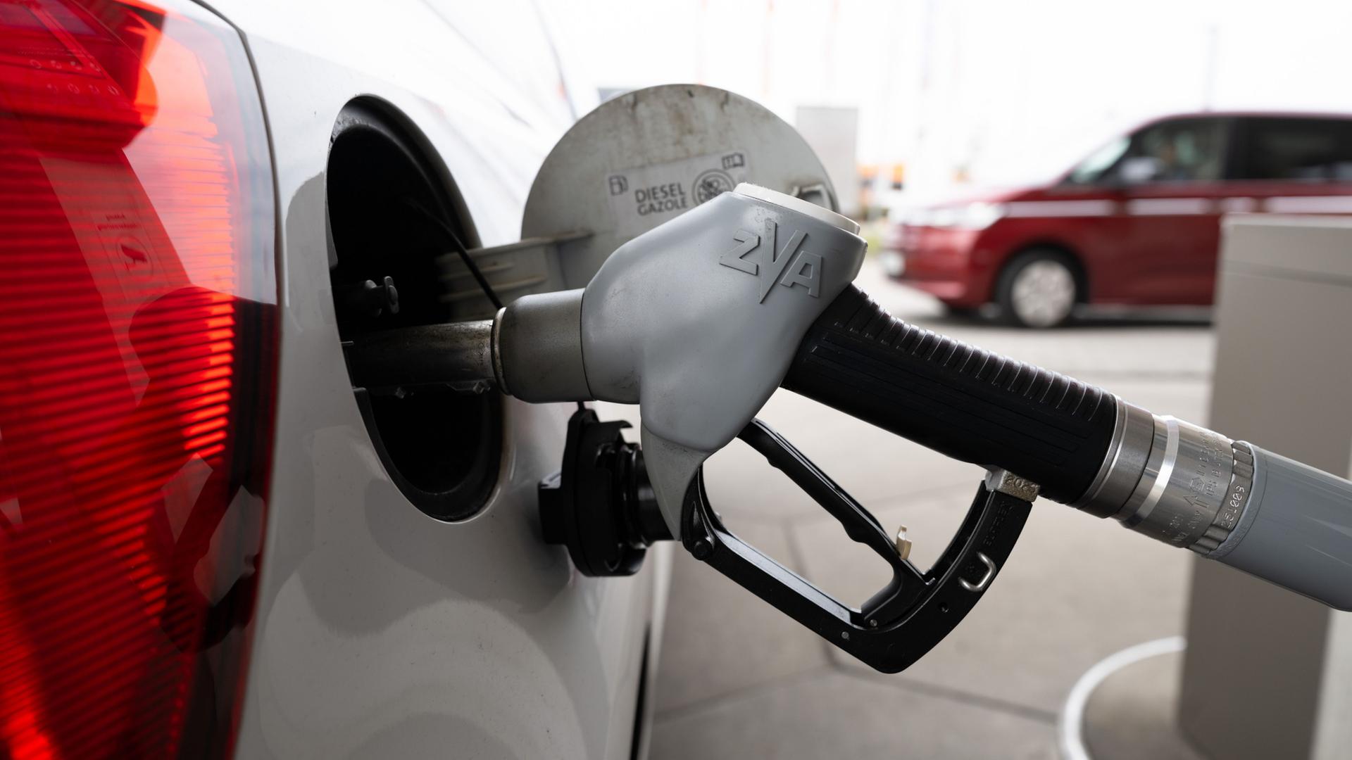 Ein Tankstutzen steckt an einer Tankstelle in der Tanköffnung eines Fahrzeugs. | Sebastian Kahnert/dpa