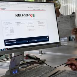 Eine Mitarbeiterin sitzt im Jobcenter am Computer.