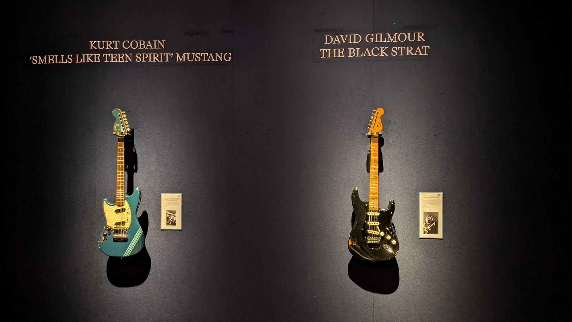 Zwei ikonische Gitarren: Die Fender Mustang von Nirvana-Frontmann Kurt Cobain (l) und die schwarze Fender Stratocaster von Pink-Floyd-Gitarrist David Gilmour. | dpa