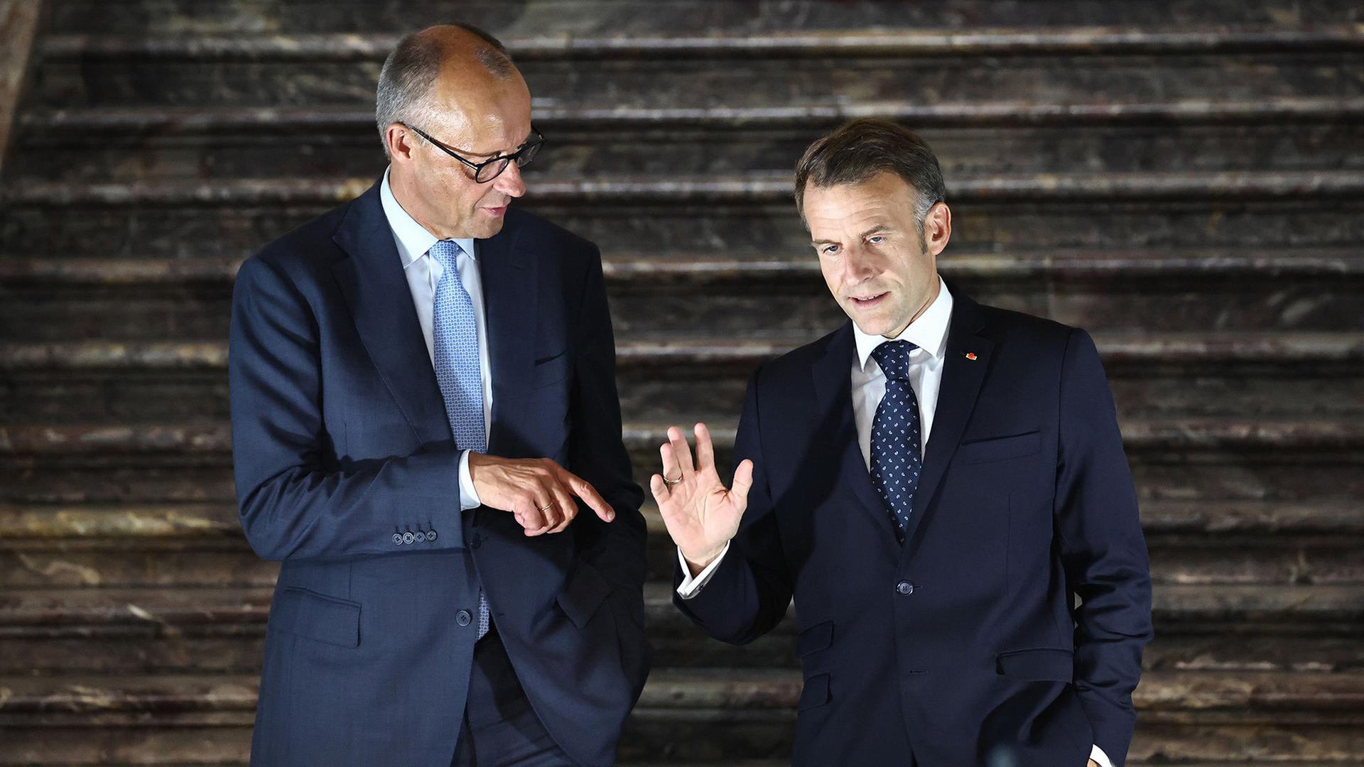 Friedrich Merz (links) und Emmanuel Macron | Oliver Berg/dpa