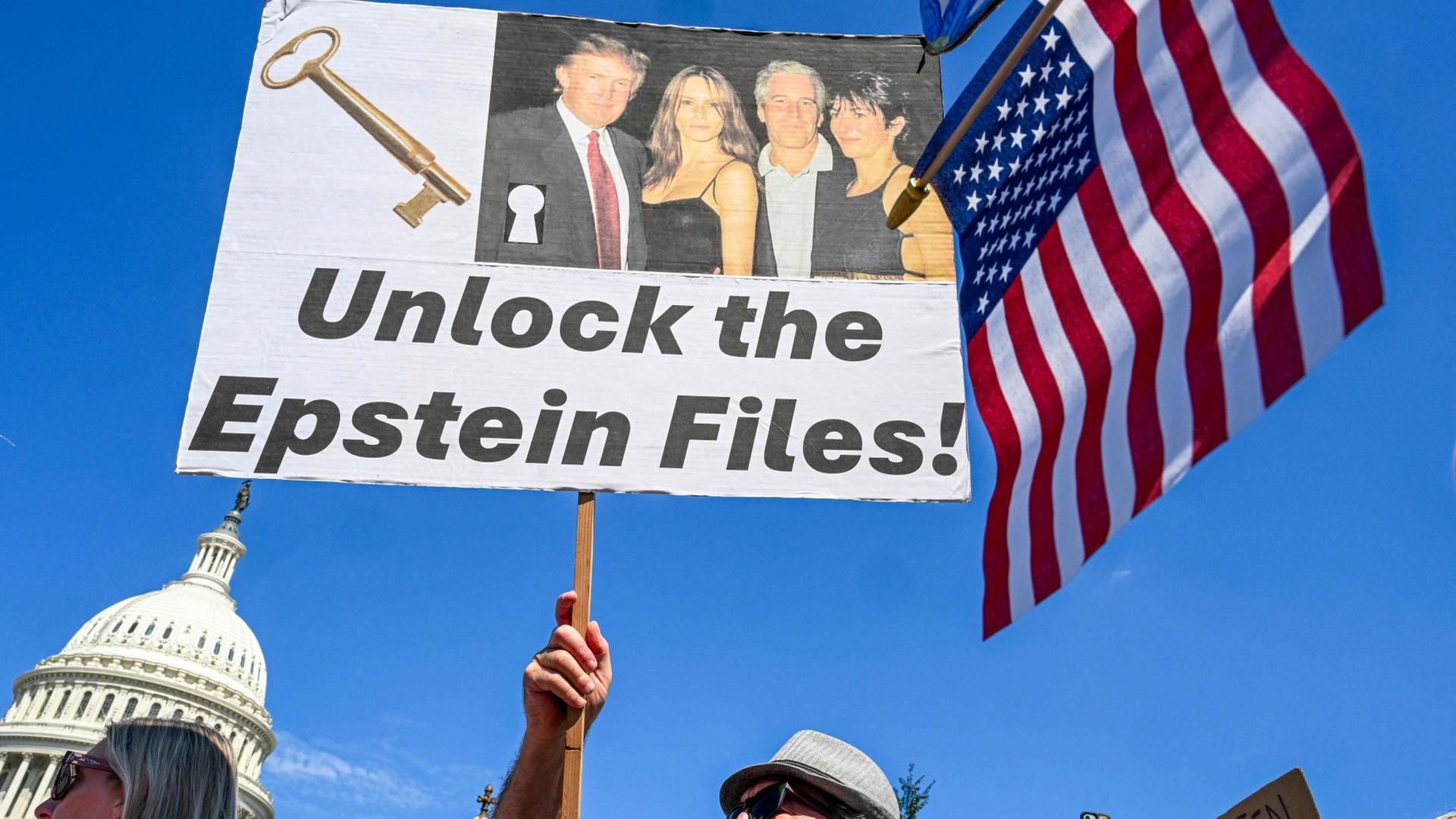 Ein Demonstrant hält ein Plakat mit einem Bild von Donald Trump und Jeffrey Epstein in die Höhe, mit dem die Herausgabe der Akten gefordert wird. | AFP