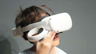 Ein Junge mit einem Virtual-Reality-Headset Meta Quest.