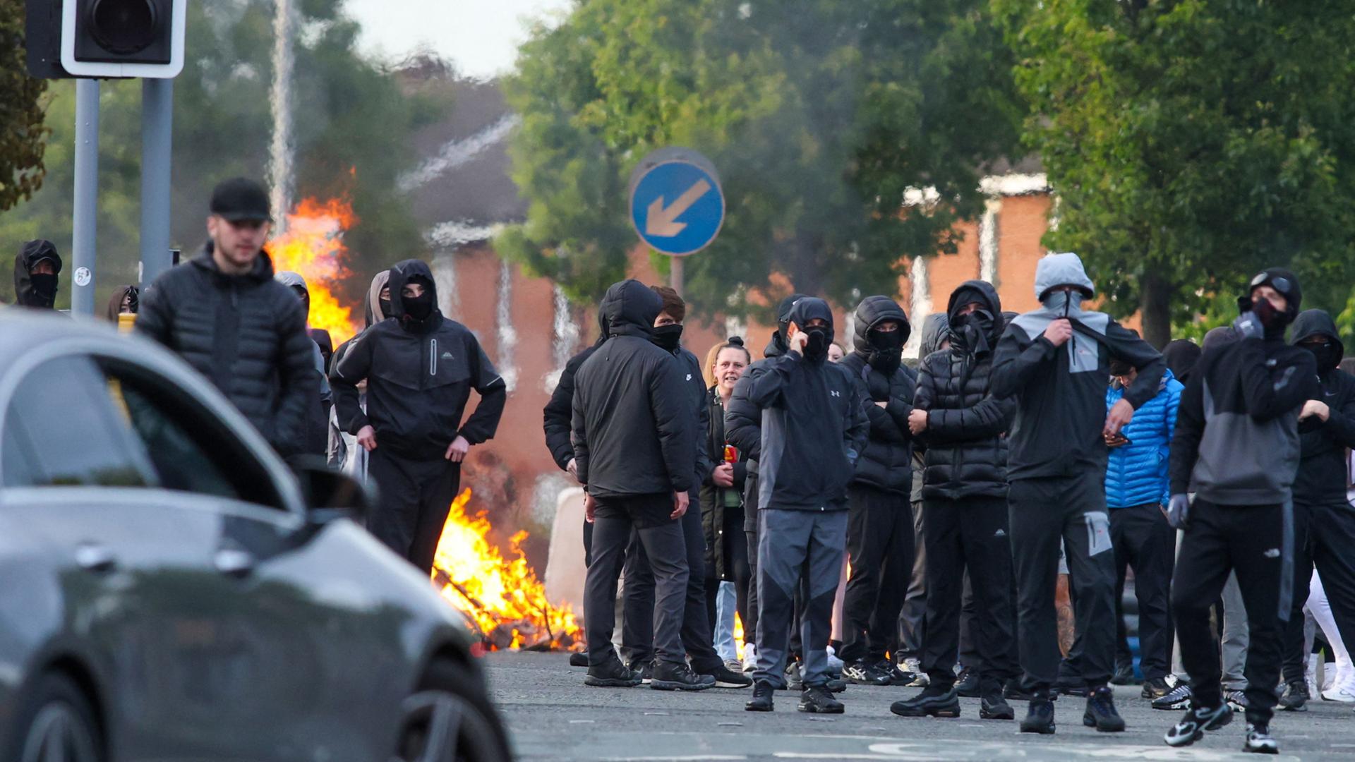 Maskierte Jugendliche vor einer brennenden Barrikade in Belfast | AFP