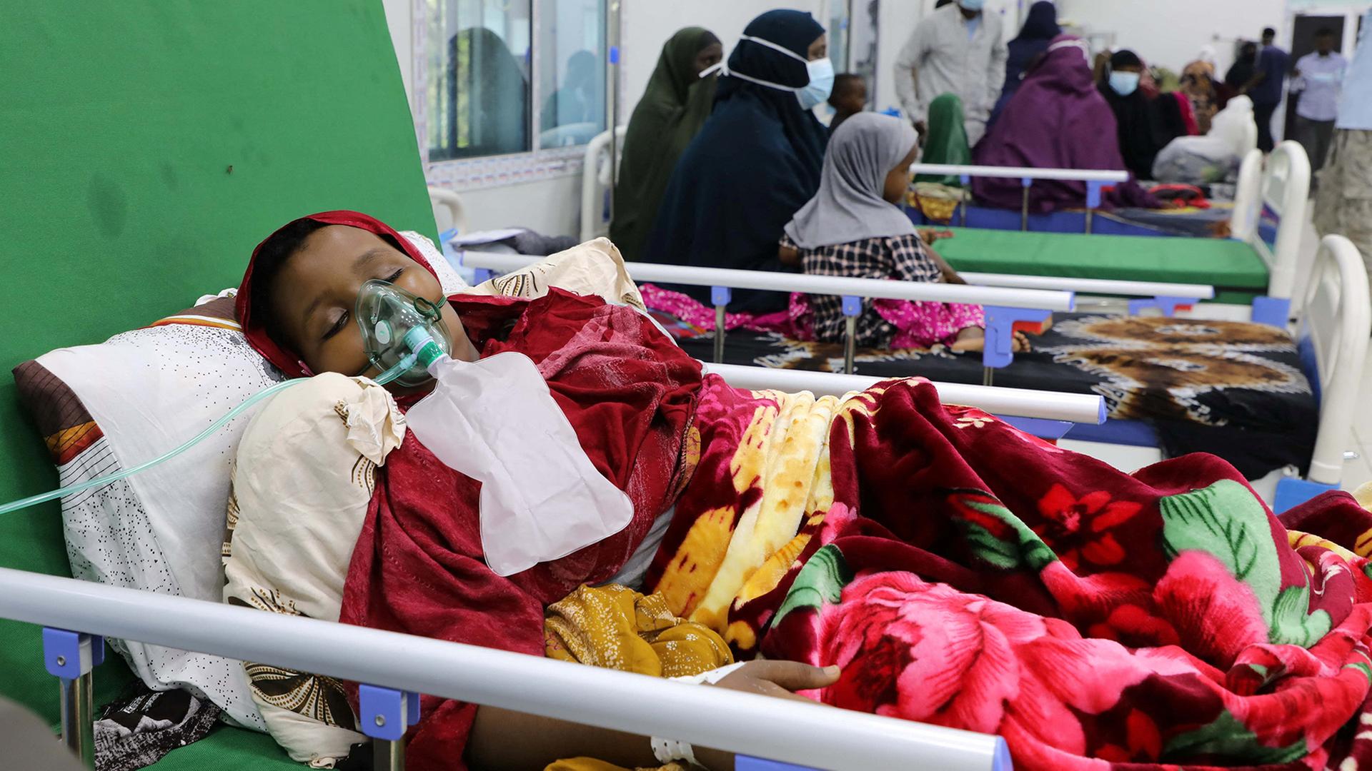 Ein Kind liegt in einem Krankenbett und trägt eine Beatmungsmaske. | REUTERS
