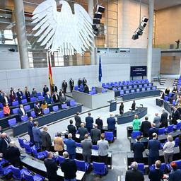 Abgeordnete stehen zu Beginn der 42. Plenarsitzung der 21. Legislaturperiode im Deutschen Bundestag.