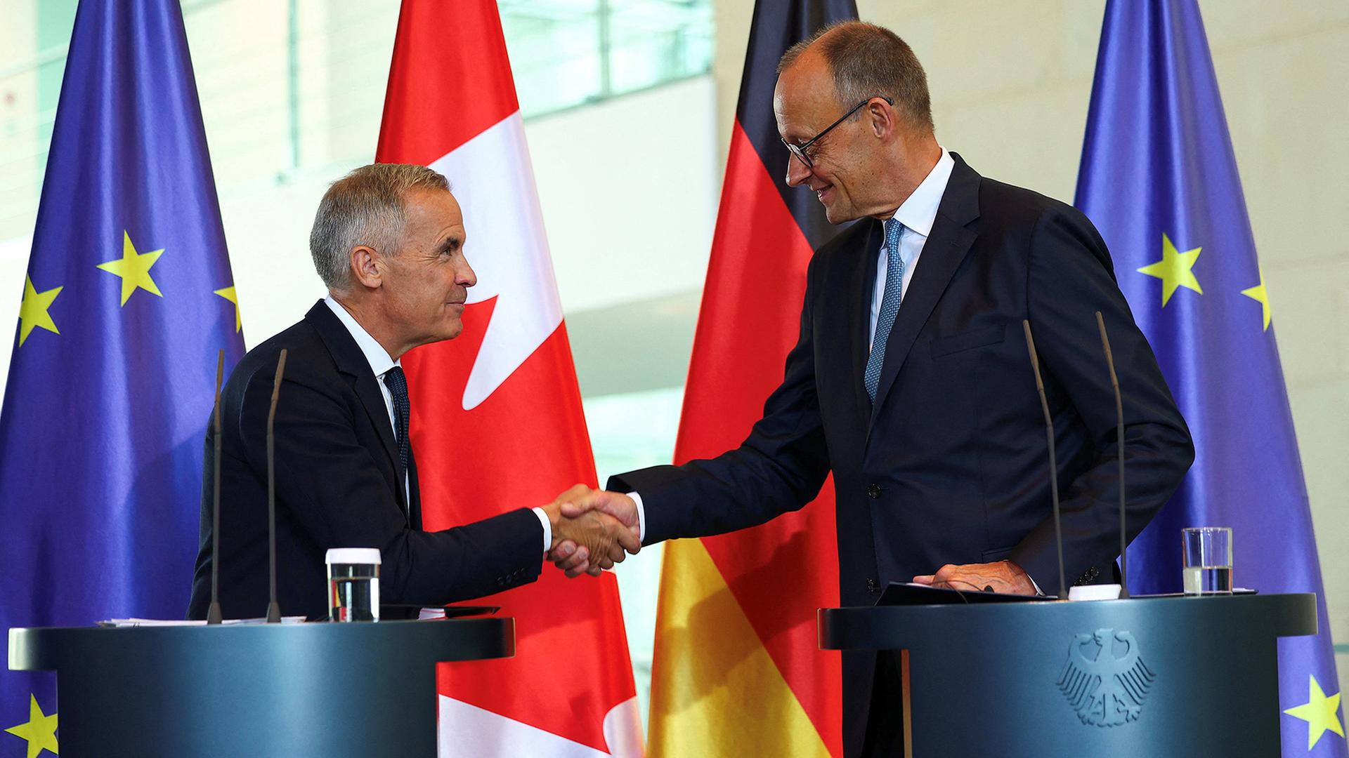 Mark Carney und Friedrich Merz geben sich die Hand. | REUTERS