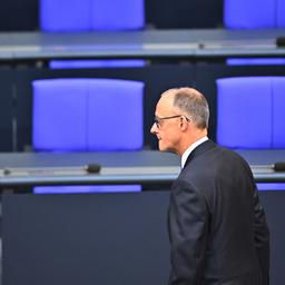 Friedrich Merz vor leeren Sitzen im Bundestag