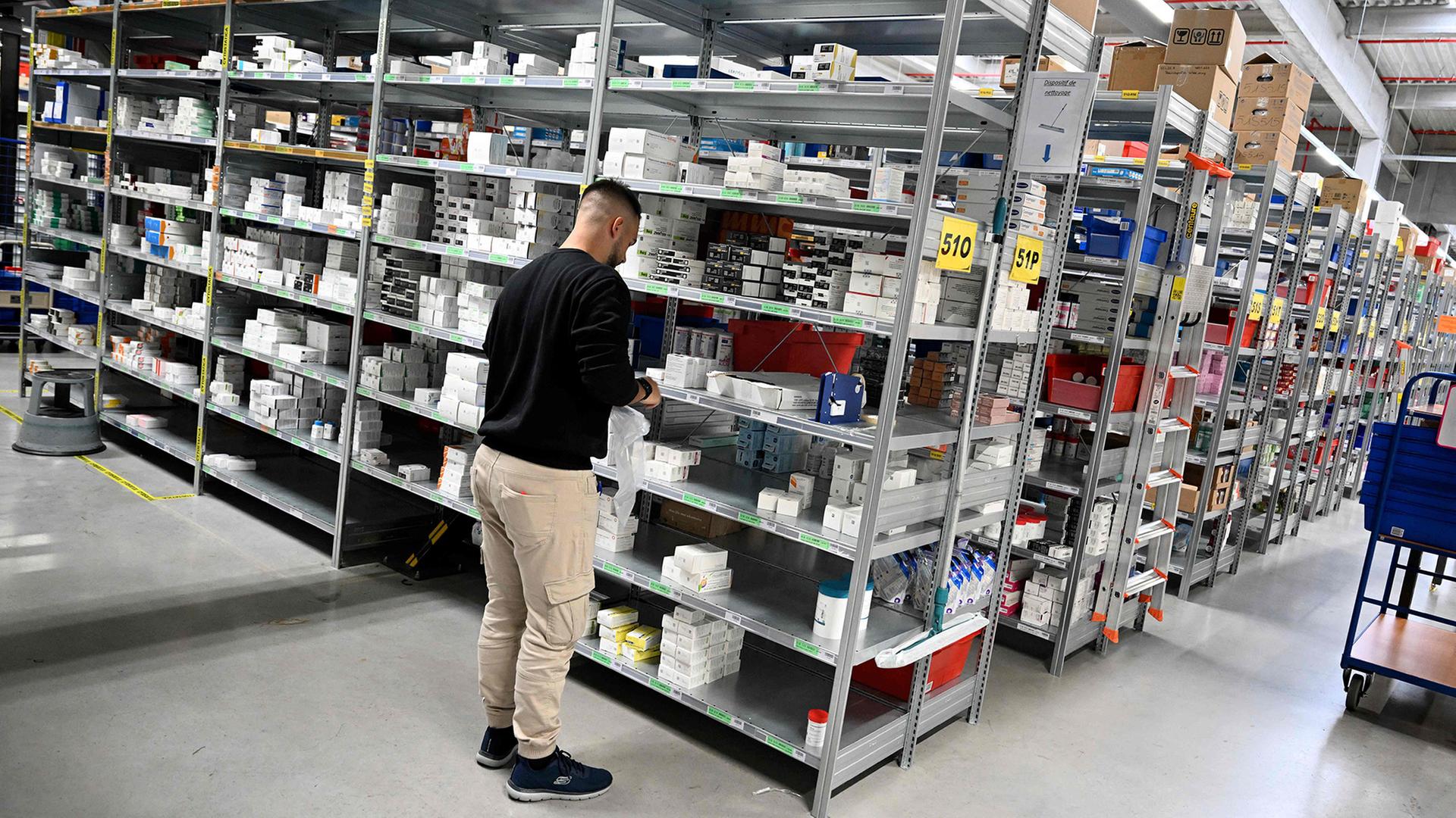 Ein Mann steht im Lager eines Medikamentengrosshandels. | AFP