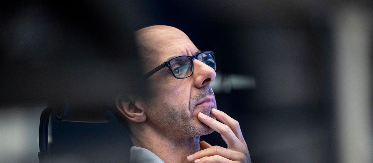 Ein Börsenhändler an der Börse Frankfurt blickt auf seine Monitore.