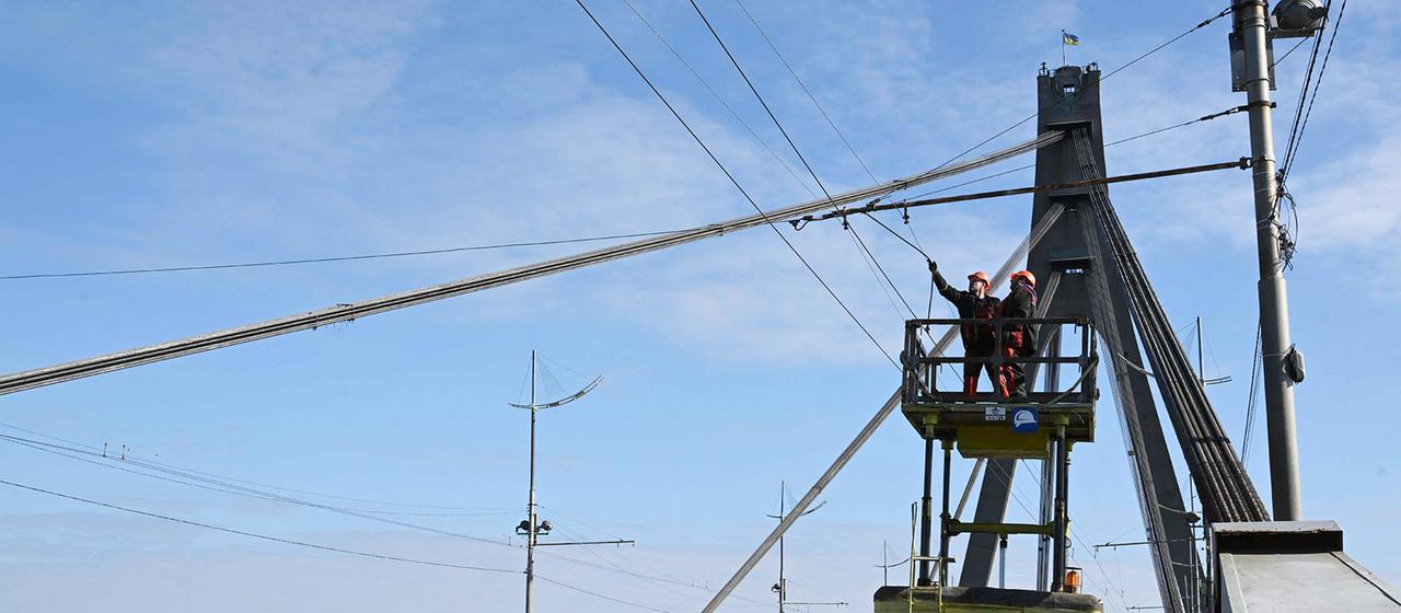 Elektrische Leitungen über einer Brücke in Kiew werden repariert