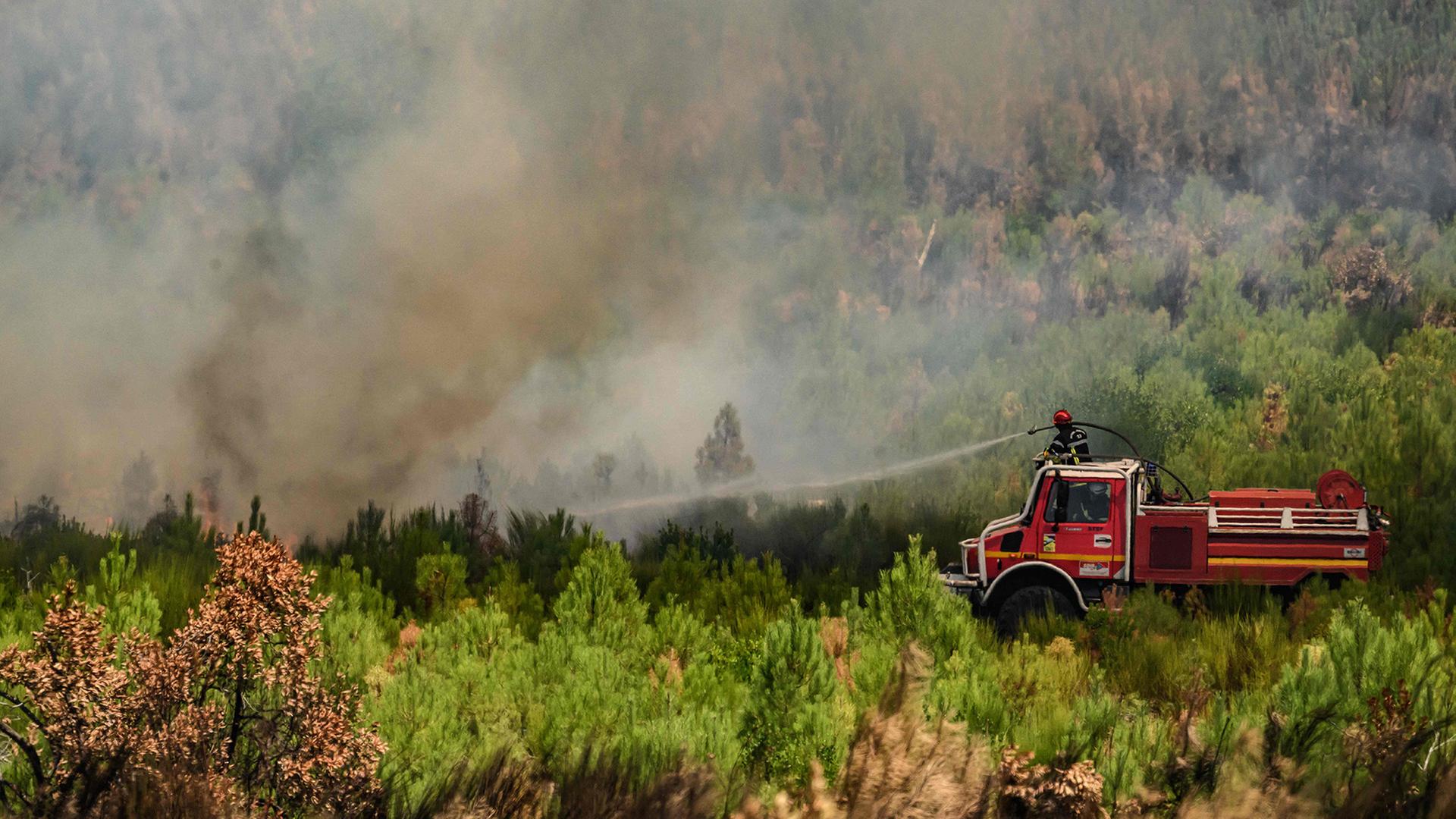 Feuerwehrleute bekämpfen die Flammen bei einem Waldbrand nahe Lège-Cap-Ferret im Südwesten Frankreichs. | AFP
