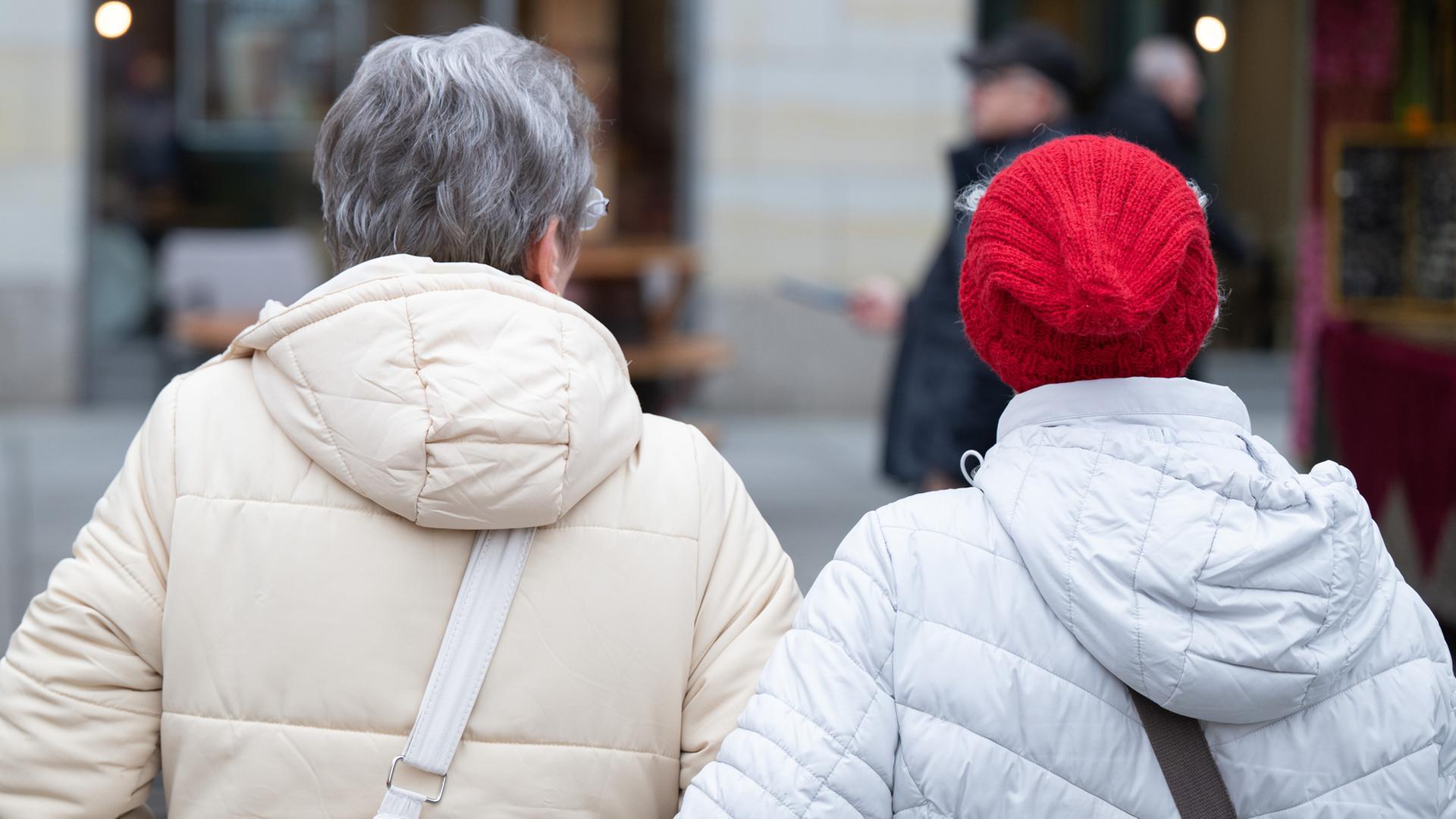 Zwei ltere Frauen gehen eingehakt durch eine Einkaufsstrae. | picture alliance/dpa