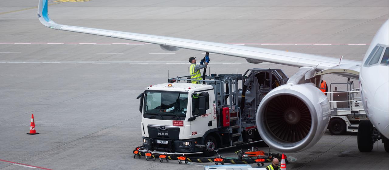 Ein Flugzeug steht am Flughafen und wird betankt.