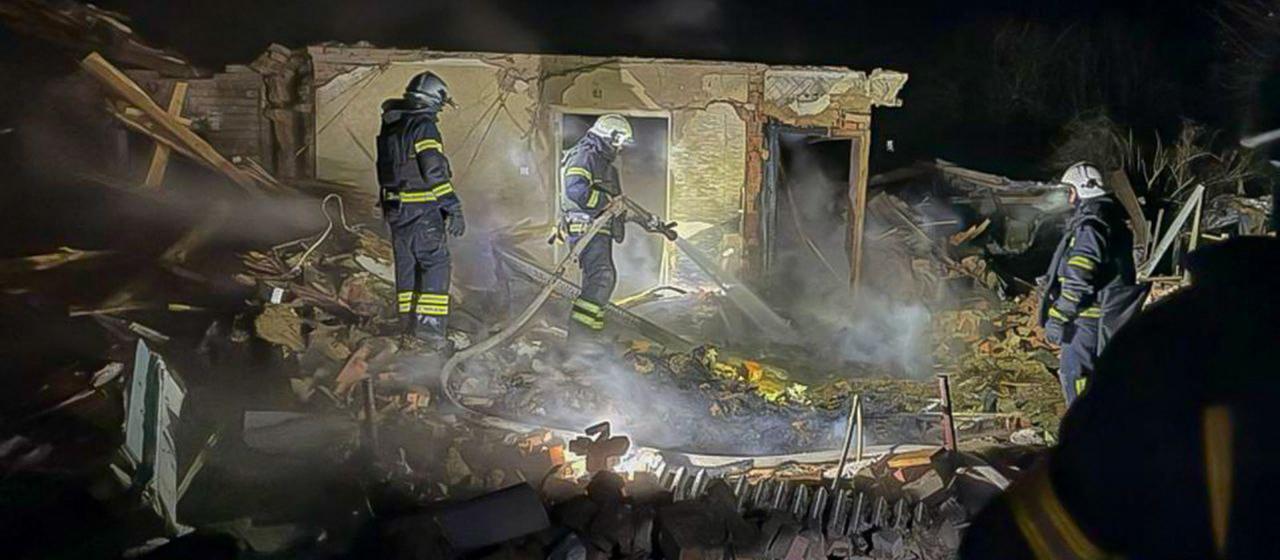 The image provided by the Ukrainian civil protection agency shows firefighters extinguishing a fire at a residential building in the Kharkiv region
