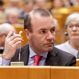 Der CSU-Europaabgeordnete Weber hält während einer Debatte einen Kopfhörer in der Hand
