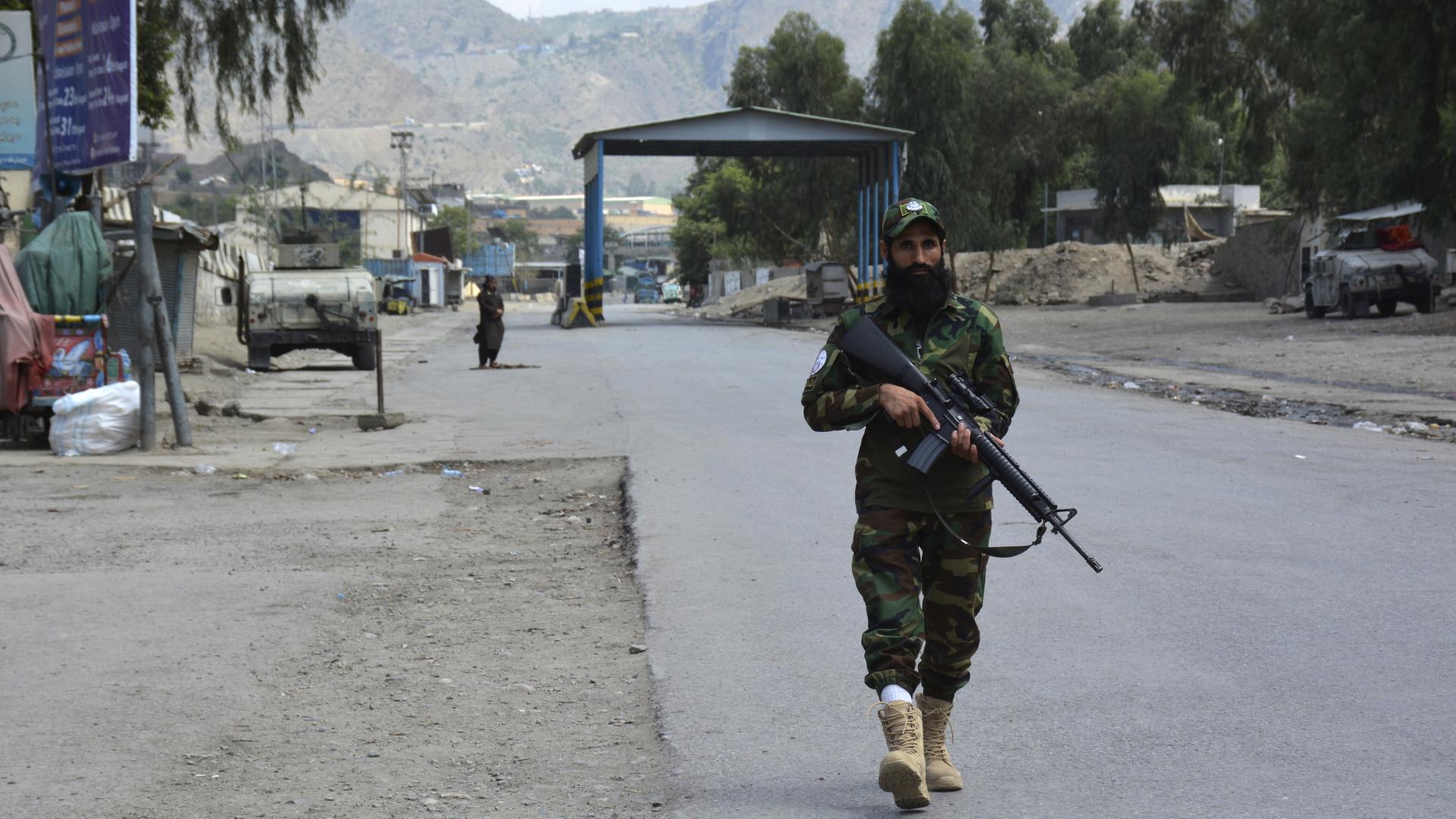 Ein Soldat der Taliban patrouilliert mit Gewehr in Afghanistan (Archiv) | dpa