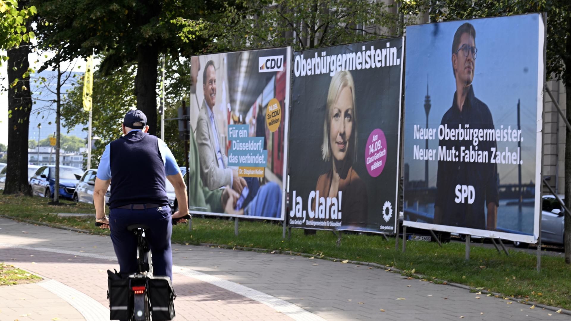 Ein Radfahrer fährt an Wahlplakaten der Parteien in Düsseldorf vorbei. | dpa