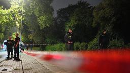 Polizisten an einem Absperrband
