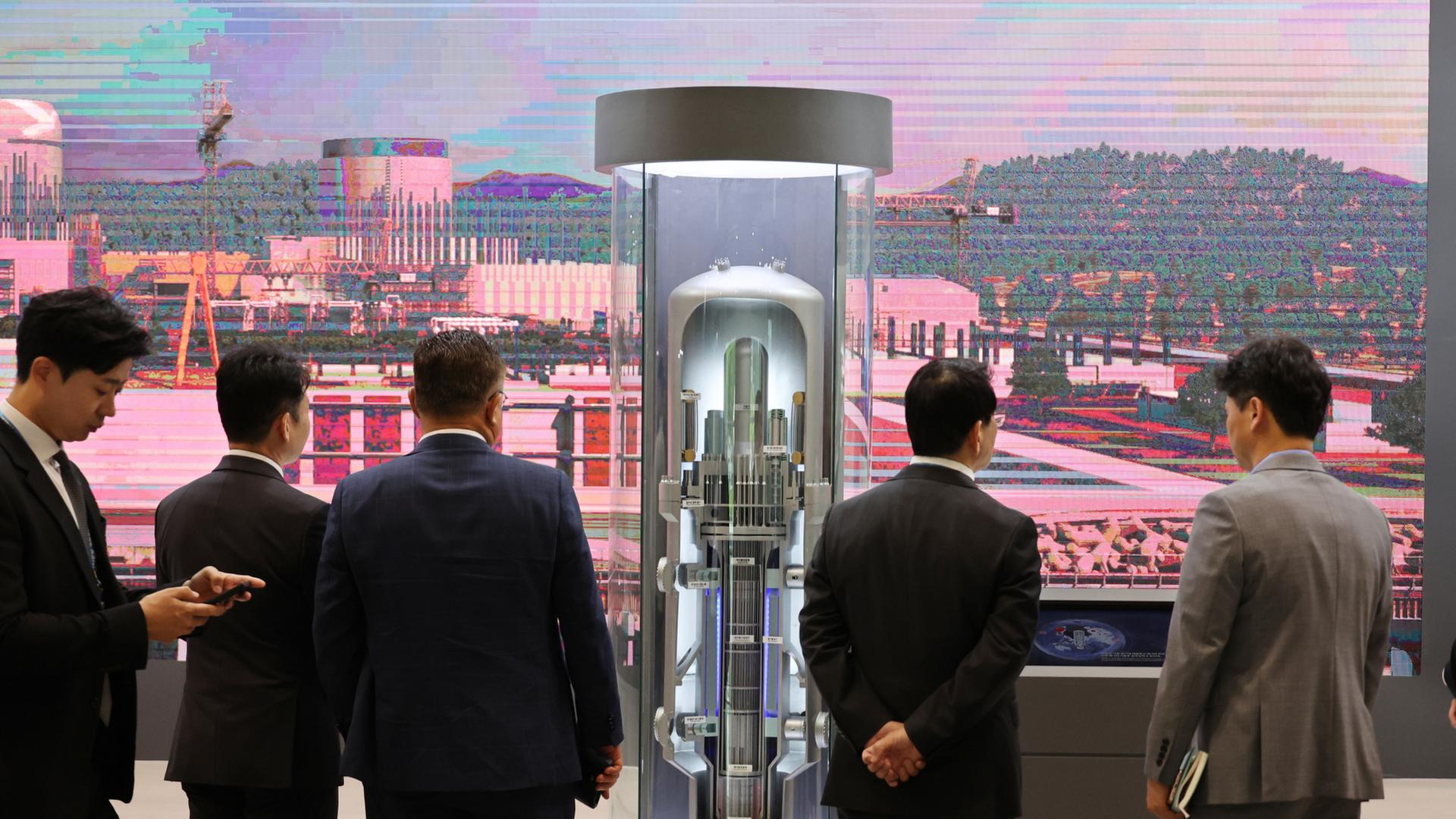 Besucher betrachten ein Modell eines kleinen modularen Reaktors während der Internationalen Kernenergie-Messe im Ausstellungszentrum BEXCO in Busan, Südkorea. | EPA